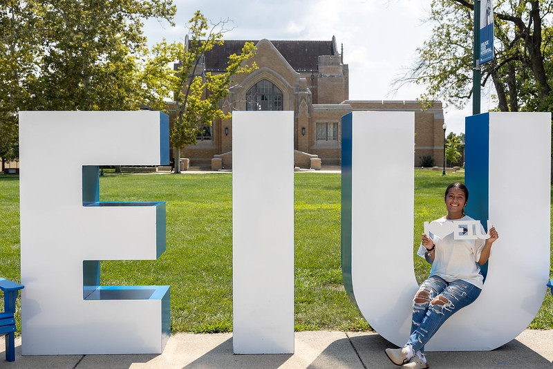 letters-eiu with young woman sitting on u
